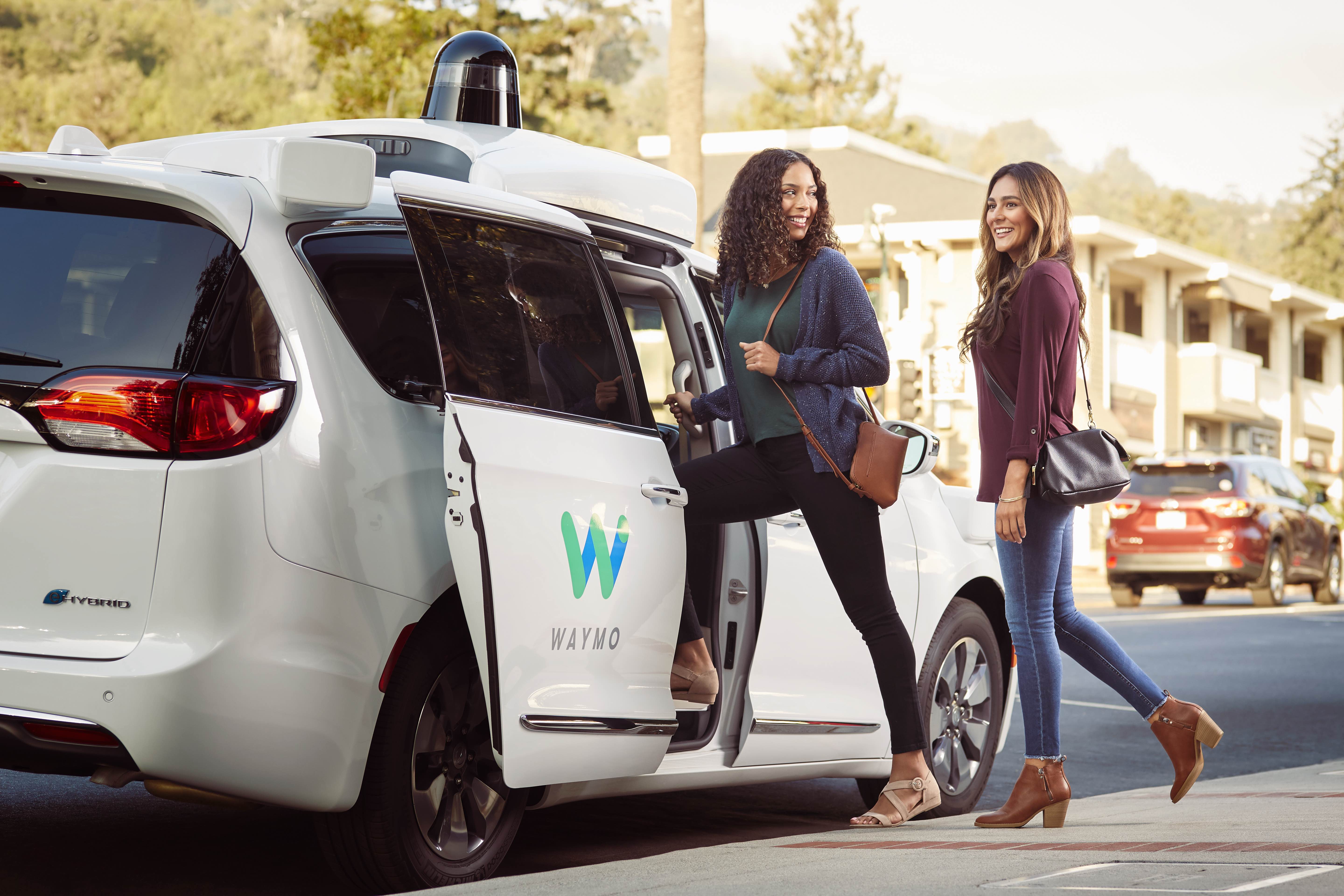 Waymo Passenger Clutches Small Dog as Vandals Surround Vehicle