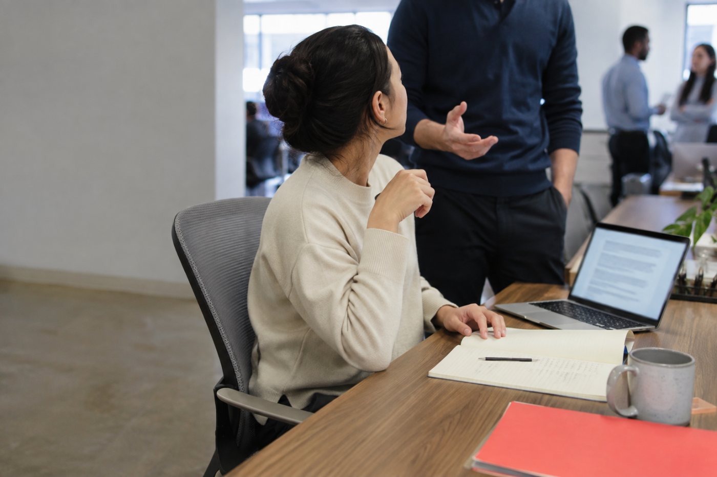 An office interruption forces a hybrid employee to switch tasks before returning to unfinished work.