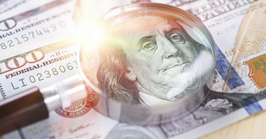 Денежный мешок в руках лица, сфокусированного на выражении лица.