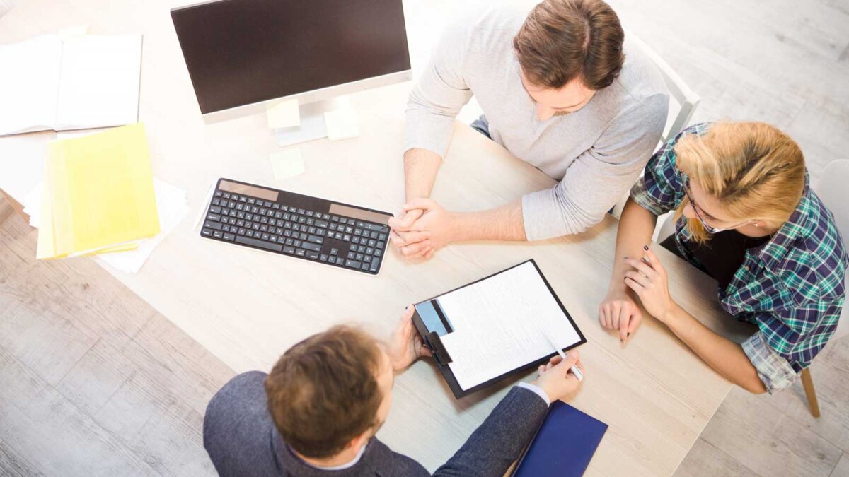 Клавиатура компьютера на столе с монитором, взрослый мужчина, лицо.