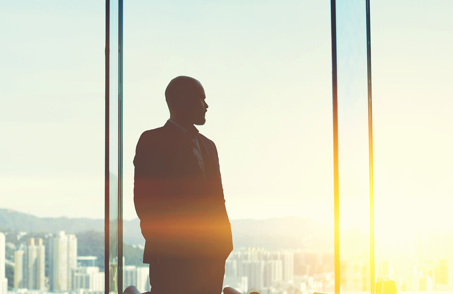 "Silhouette of an adult male person with focused expression, showing half face and head."