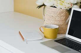 "Modern laptop on desk with electronics, cup, book - stylish home office furniture"