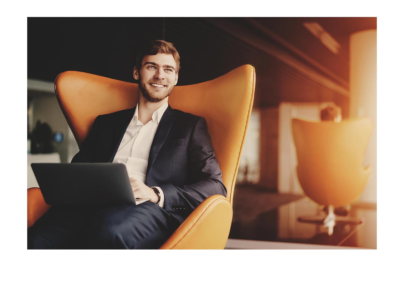 Человек мужчина сидит за ноутбуком, улыбается, портрет.