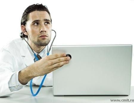 Фотография человека в лабораторной халате с курительной трубкой, окруженного компьютерной техникой.