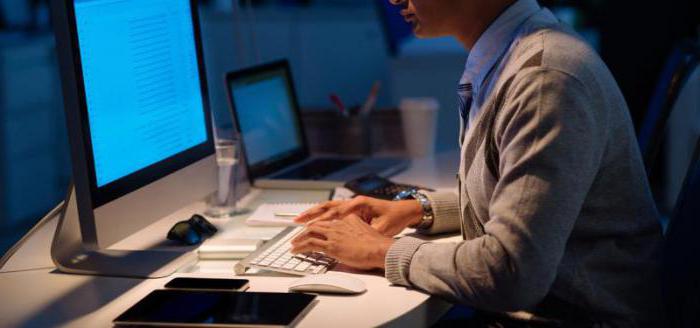 Стол с компьютером, монитор, ноутбук, клавиатура, электроника на рабочем месте.