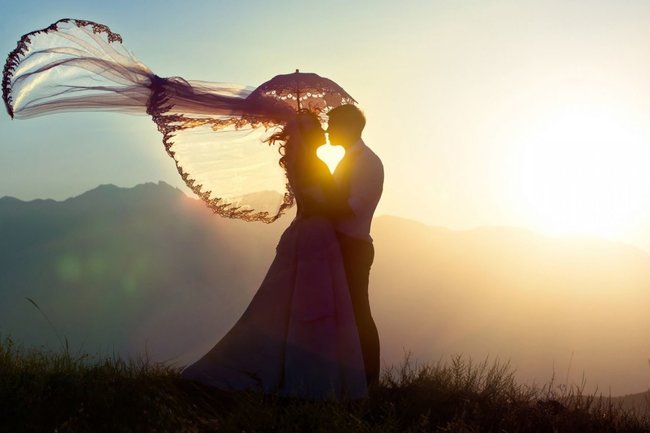 Фотография человека в полупрозрачном платье под ярким солнечным небом на природе.