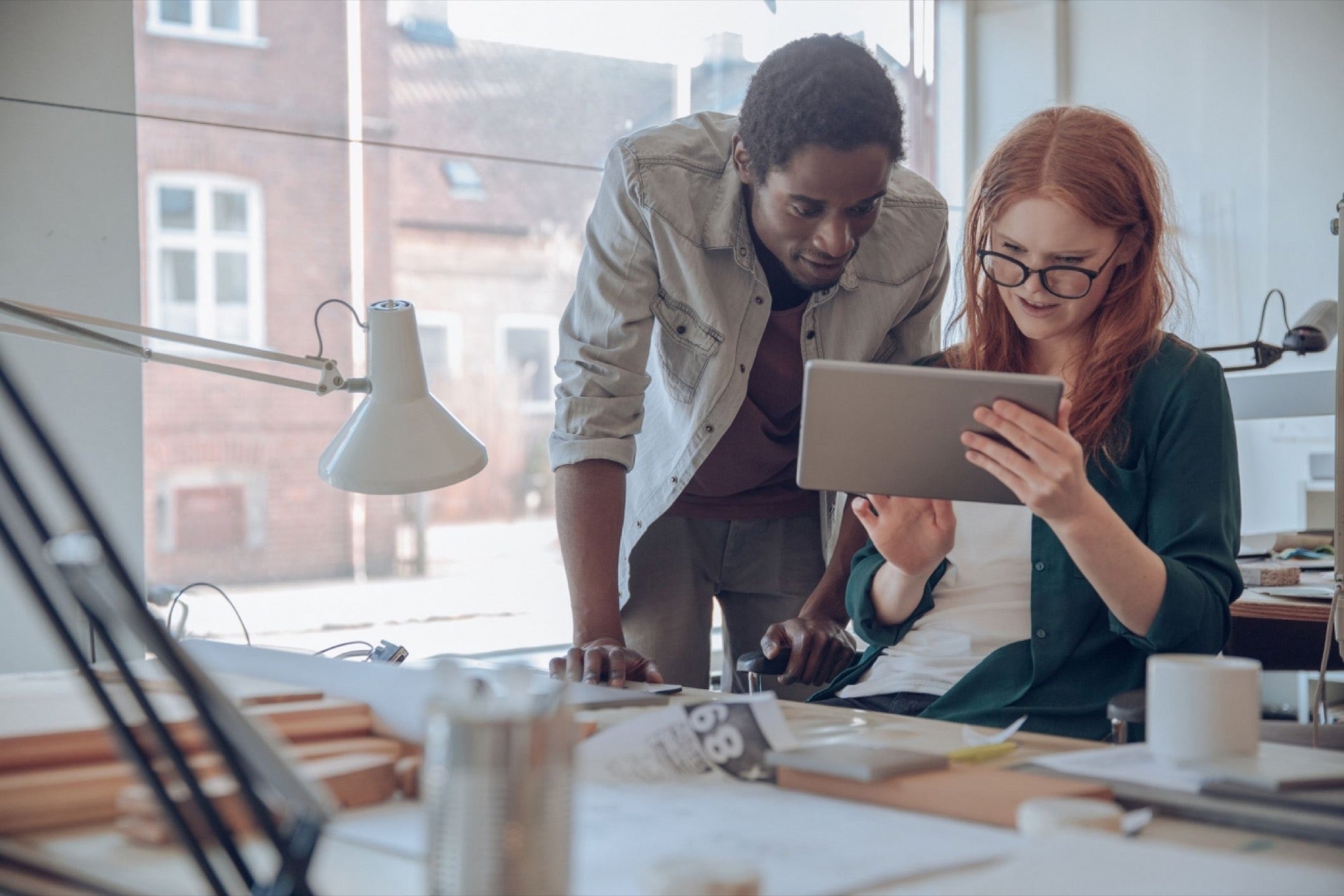 "Female executive using tablet computer, showcasing adult woman with focused face in electronics."