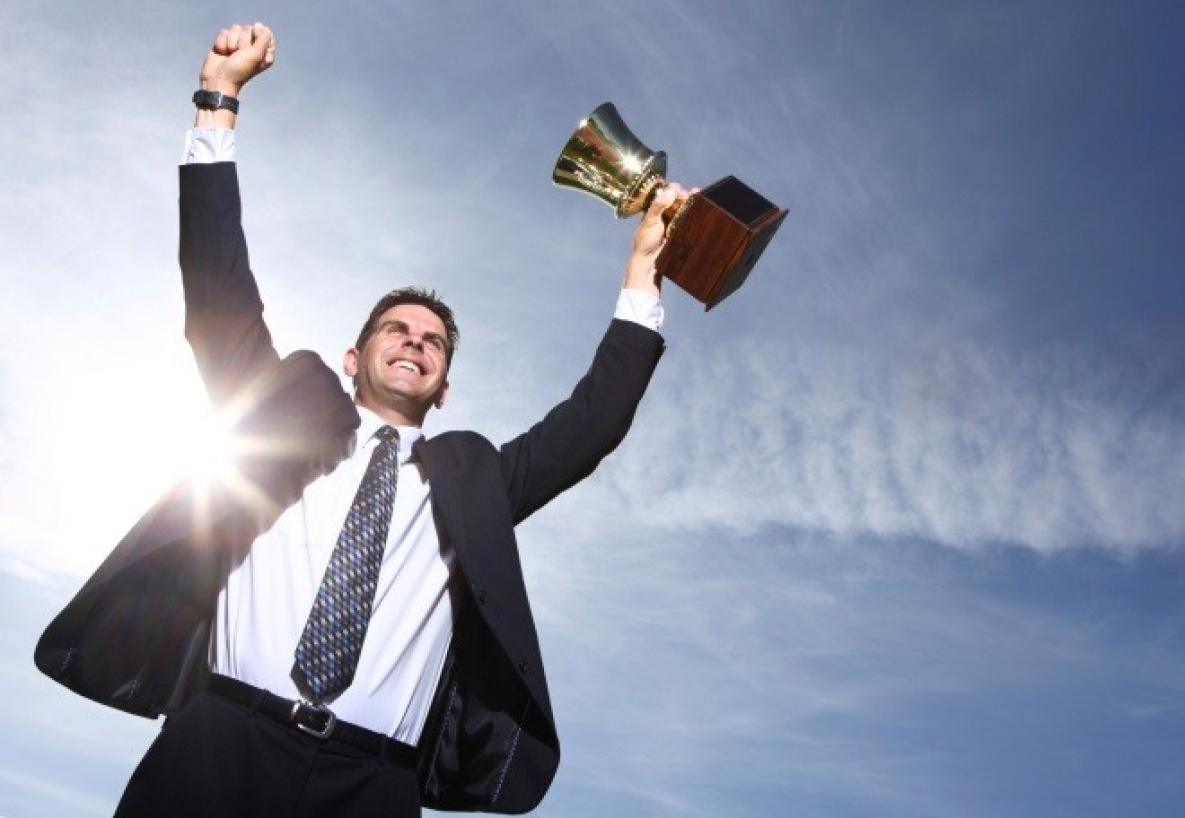 "Happy adult male in a tie, with a triumphant expression on face."