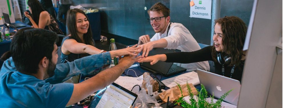 "Adult man and woman indoors, facing each other with laptop, focused expressions."