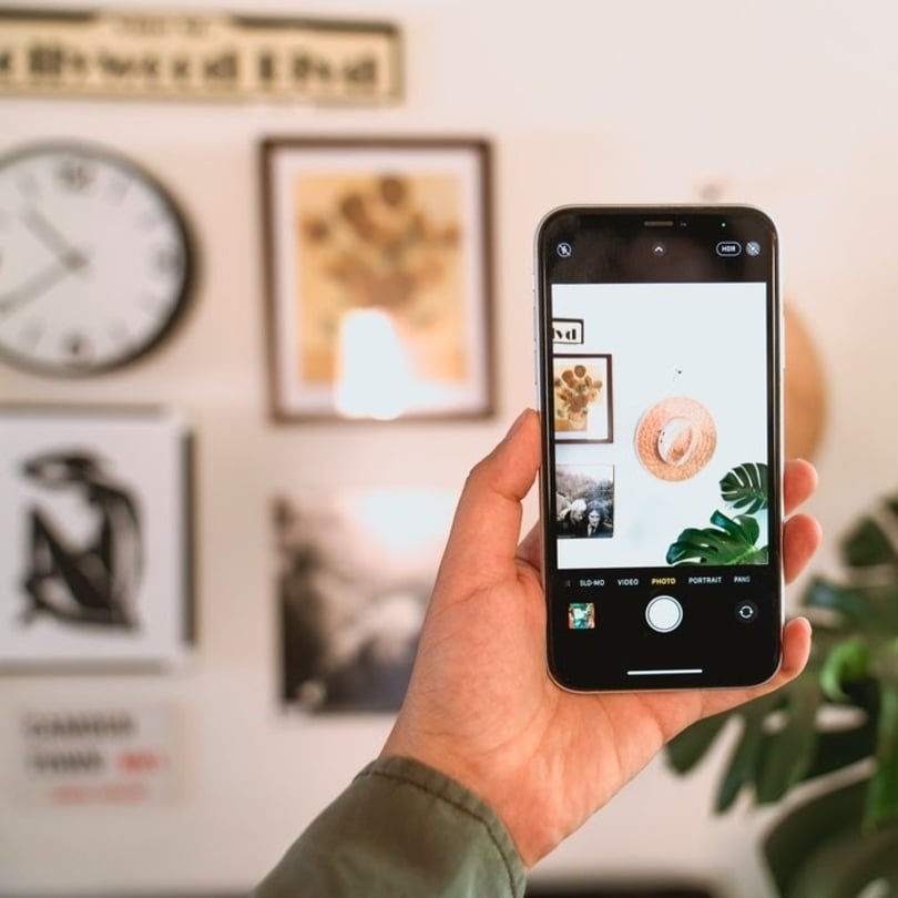 "Close-up image of modern smartphone and digital photo frame on display"