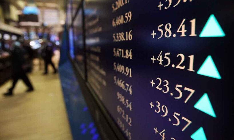 Взрослый мужчина смотрит на монитор компьютера с текстом и символами.