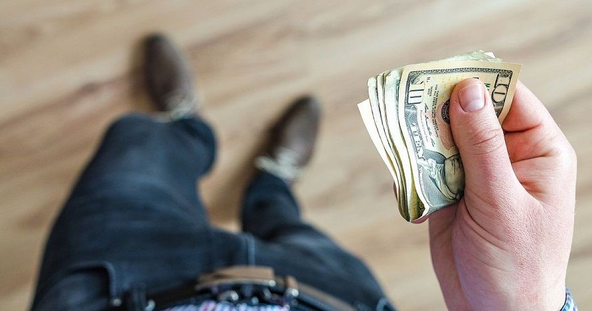 Человек с деньгами, суммка, деньги на столе, купюры, лента денег.