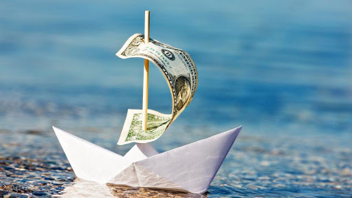 Деньги. Стопка долларов разбросана на столе. Финансовый успех и процветание.