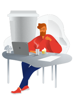 Мужчина сидит за столом с ноутбуком и компьютером на рабочем месте.