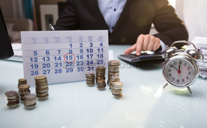 Человек работает за компьютером, на мониторе отображается текст и электроника.