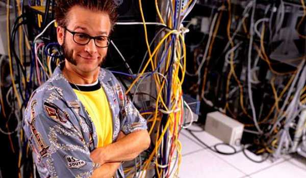 Мужчина настраивает сервер с проводкой, компьютерной аппаратурой. (Male setting up server with wiring, computer hardware.)