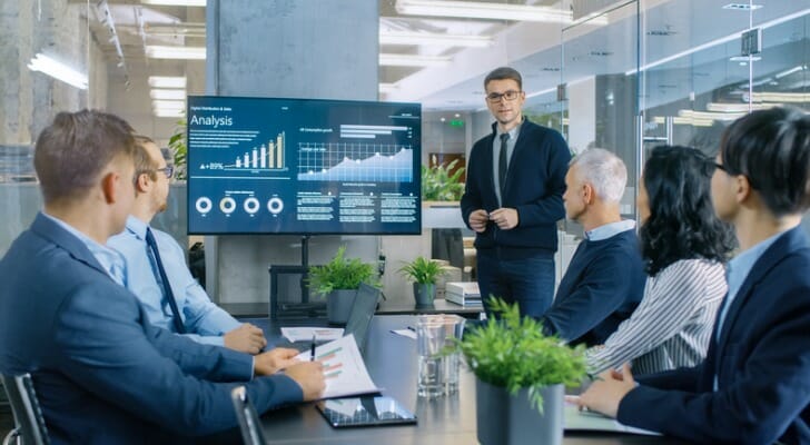 Изображение: Взрослый мужчина и женщина в офисном стиле с растениями.