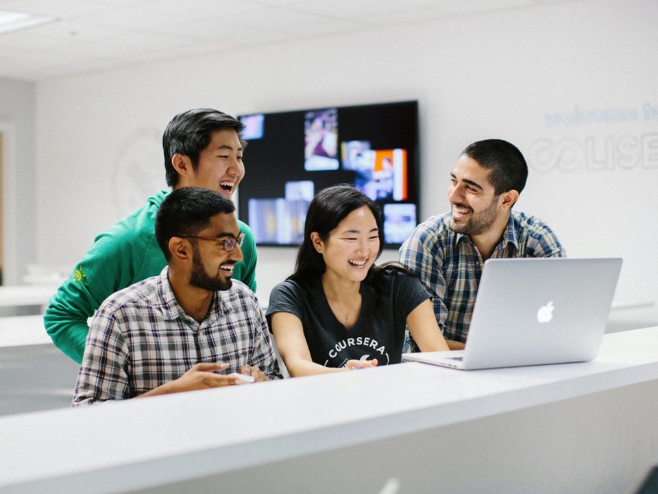 Мужчина-студент с ноутбуком в руках, концентрируется на работе.