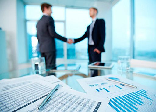 Люди в офисной обстановке на семинаре, одетые в формальную одежду.