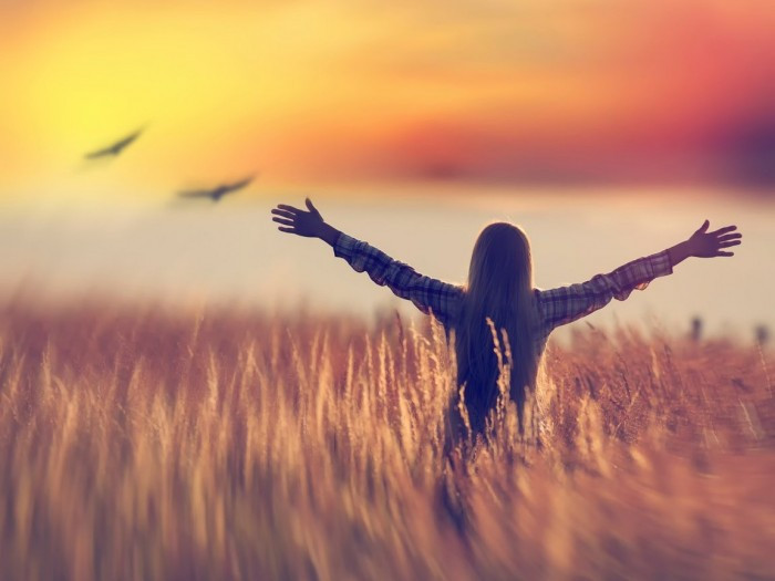 Голова радостного человека с портретом птицы на фоне природы.