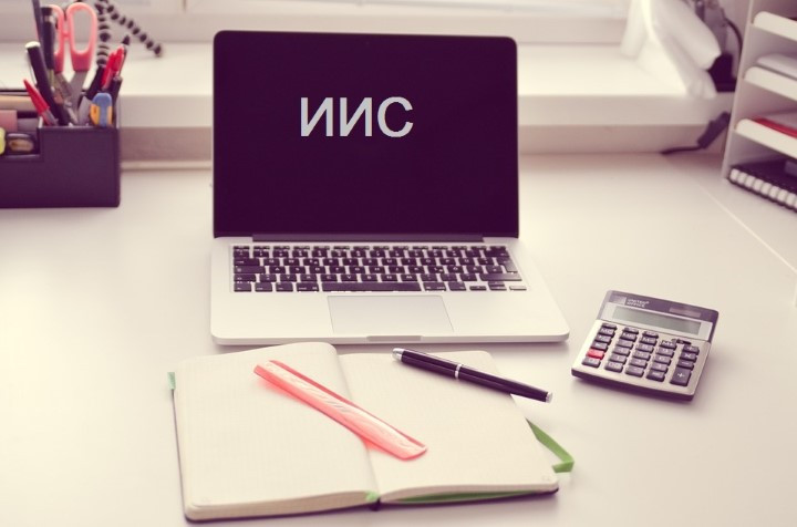 Компьютер на столе с ноутбуком, пультом и мебелью, электроника и текст.