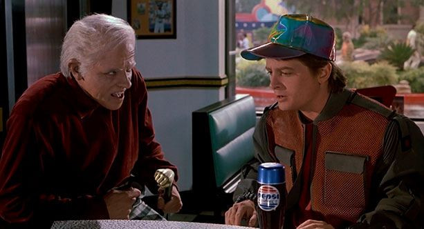 Фотография портрета взрослого мужчины в бейсбольной кепке, держащего пиво.