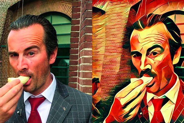 Фотопортрет взрослого мужчины с каменной стеной в красном галстуке.