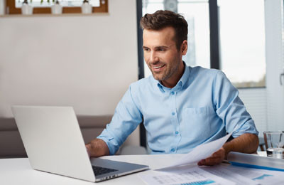 "Executive person working on laptop computer, focused face close-up view."