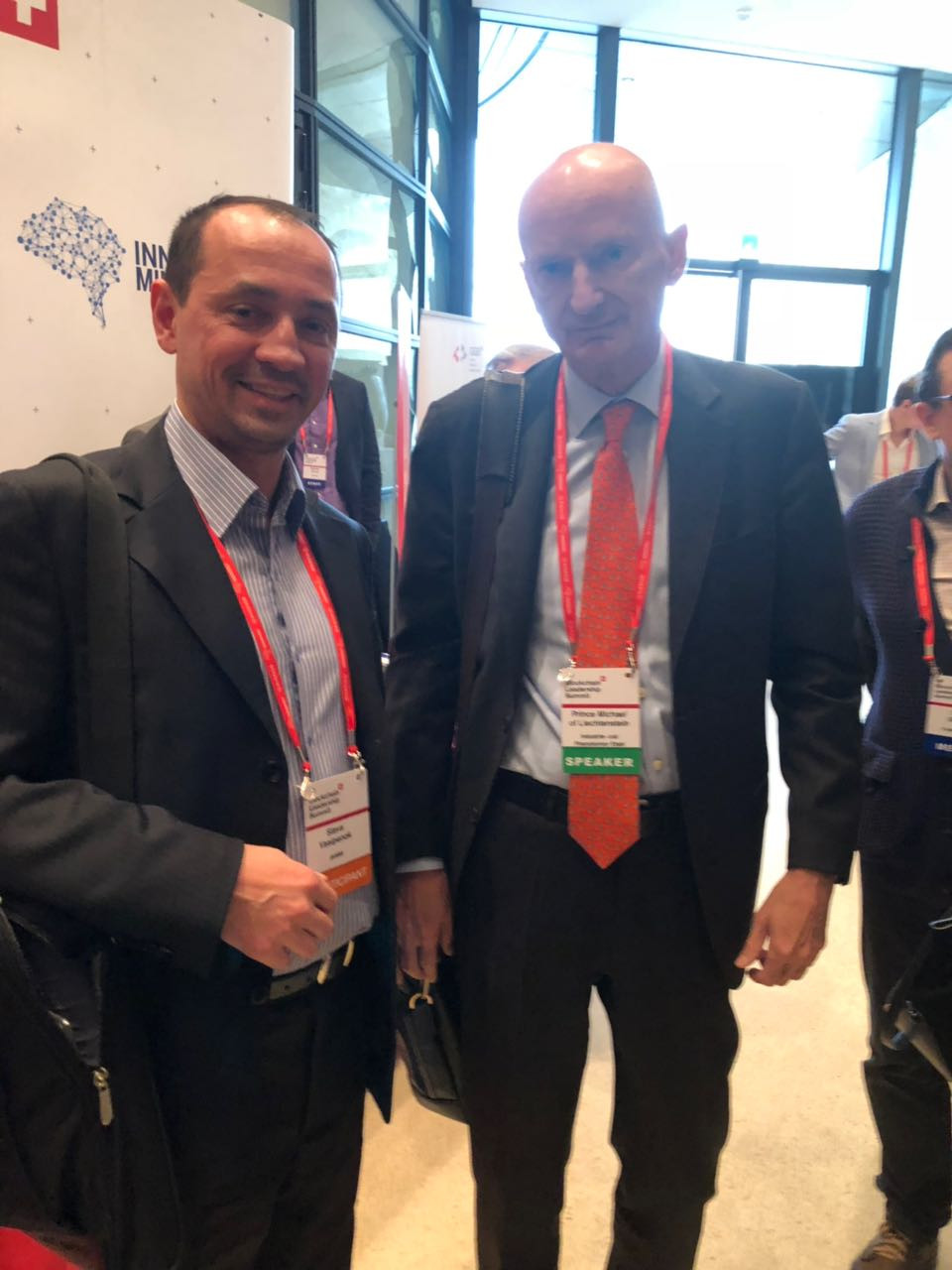 "Man in formal blazer, tie, and suit pants, posing for portrait."