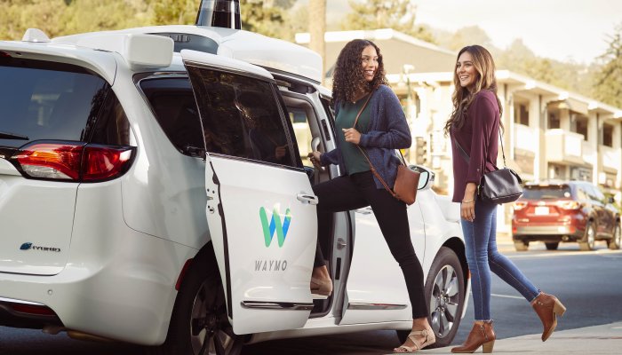 Waymo Passenger Clutches Small Dog as Vandals Surround Vehicle